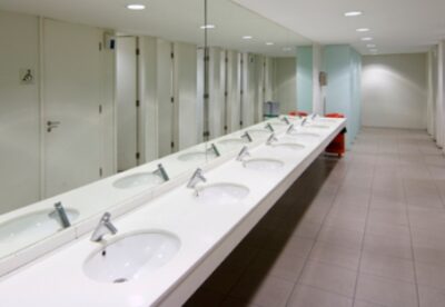 View of a public empty restroom with mirror